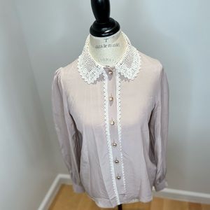 Blouse with beautiful buttons and lace collar and lace cuffs.
